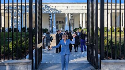 President Kate Smith at the gates in the front of the White House