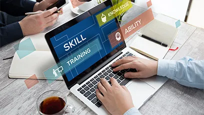 Person typing on a laptop at a desk with a phone, notebook, and coffee nearby, with overlay text reading “Skill Training,” “Knowledge,” and “Ability.”