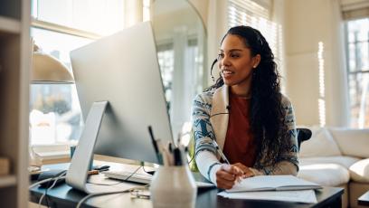 Woman on computer studying at home.
