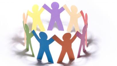 A circle of multi-colored paper dolls holding hands