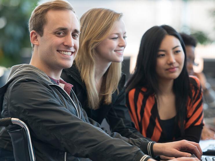 Group of students in front of laptop