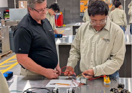 HVAC instructor works with students at the West-MEC Career Academy @ Agua Fria in Avondale, AZ.