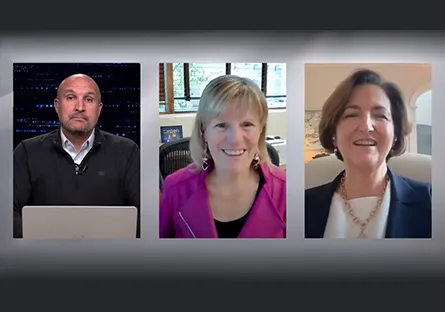Screenshot of a virtual podcast interview featuring three speakers in separate frames: a man on the left seated at a laptop, a woman in the center wearing a pink jacket and smiling, and a woman on the right wearing a blazer and necklace, also smiling.