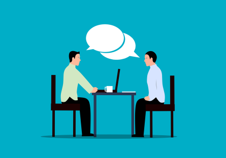 Two people having a conversation over a table