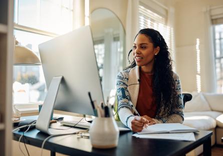 Woman on computer studying at home.