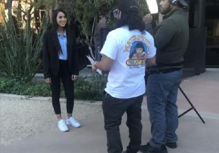 Vera Batista Cespedes being interviewed outdoors by a film crew