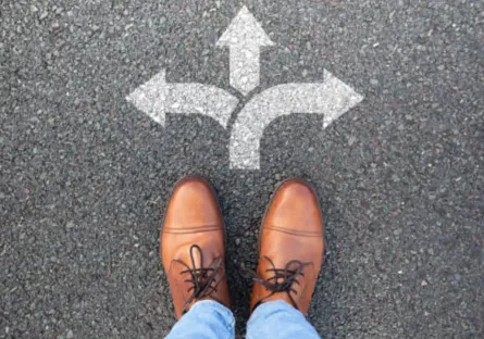 A pair of shoes stands at a crossroads